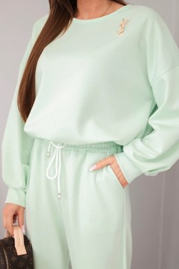 Komplet damski masełko bluza z broszką i spodnie z prostą nogawką miętowy